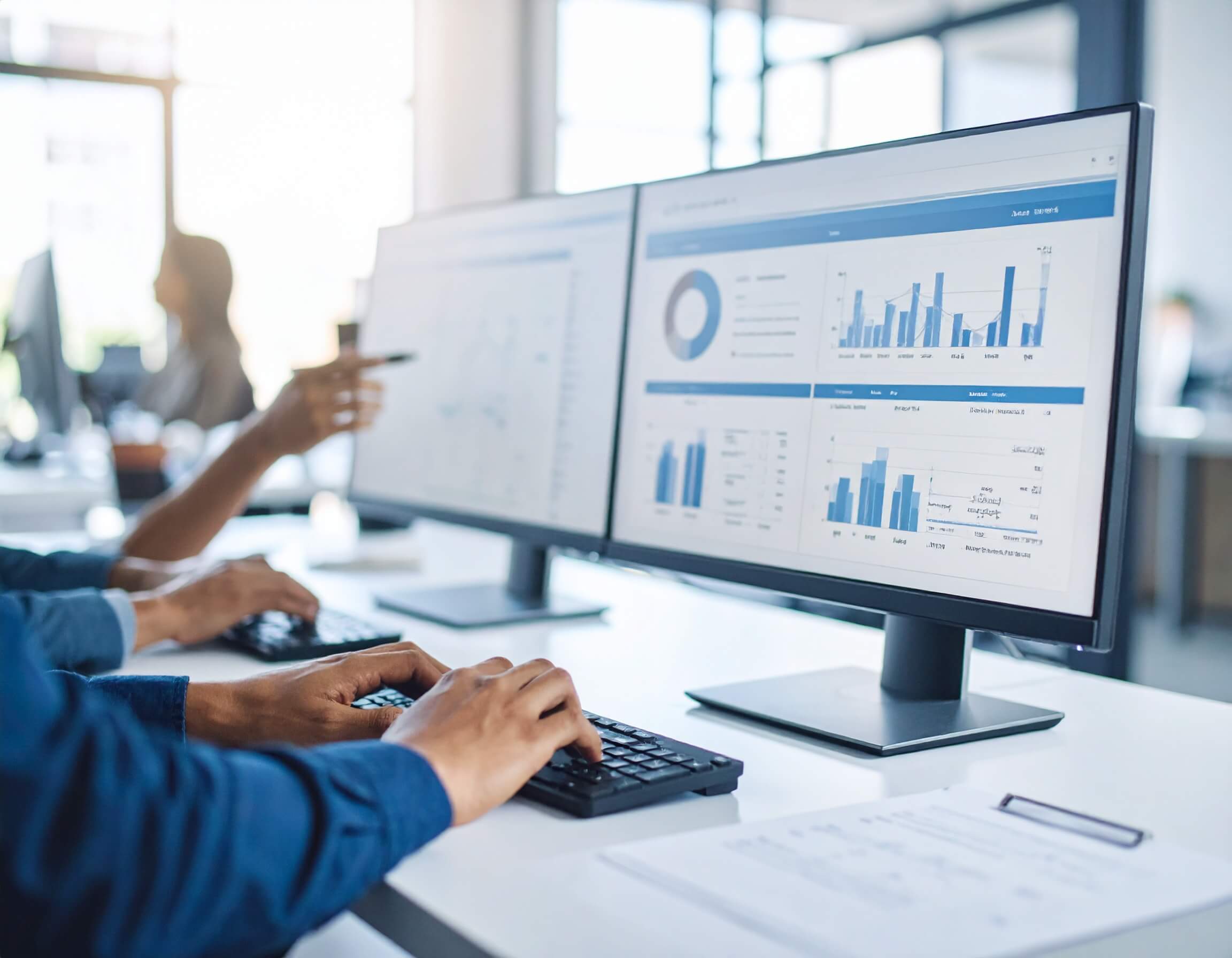 Two people looking at graphs and charts of ecommerce SEO strategy build analytics and insights reporting on a desktop computer
